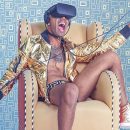 A good-looking young man sits and wears a VR headset.