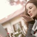 Screenshot of a girl sending flying kiss on a video call