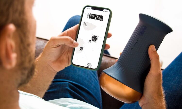 Person with penis holding the MYHIXEL device and app.